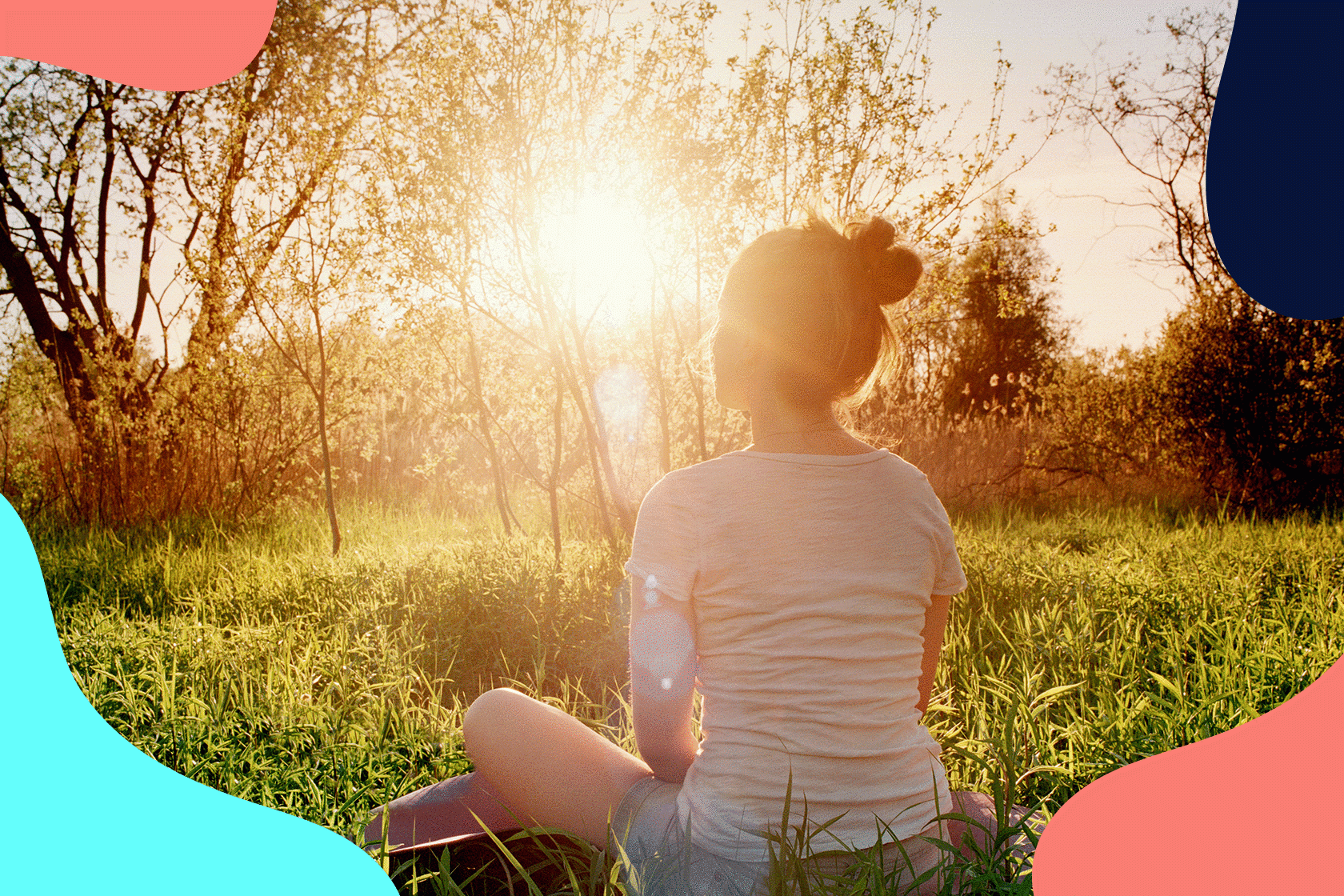 woman sat in field meditating peacefully at sunrise